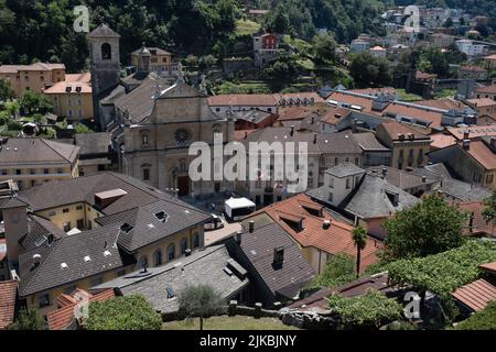 Bellinzona, the capital of the Swiss canton of Ticino, with houses and in the center the collegiate church of St. Peter and St. Stephen Stock Photo