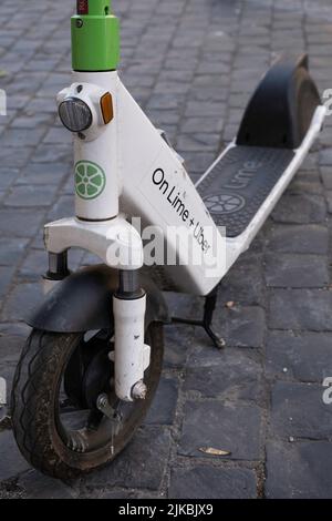 Close-up of the front wheel of an e-step or e-scooter from the company On LIME and UBER for rent in a street in Rome. Popular means of transport Stock Photo