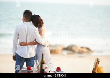 Young couple having romantic dinner on the beach Stock Photo