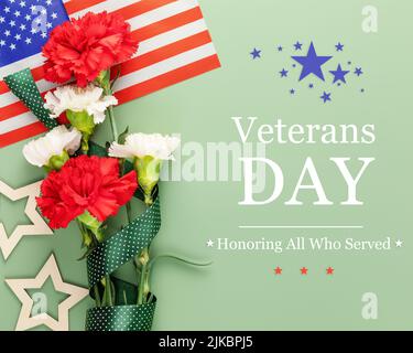 American Veterans Day card with bouquet of red and white carnations, American flag and decoration stars on a green background with inscription Veteran Stock Photo