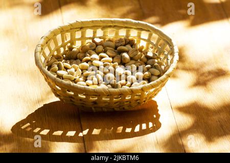 Green unroasted coffee beans in a basket Stock Photo