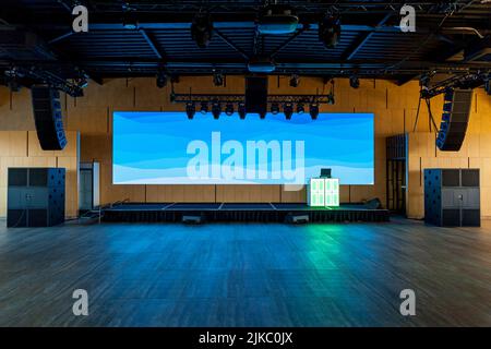 Conference hall with equipment for events. Large monitor, speakers, podium for conferences, events and parties Stock Photo
