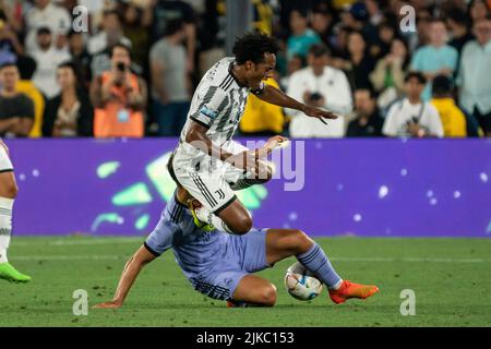 Juventus midfielder Juan Cuadrado (11) is fouled by Real Madrid midfielder Marco Asensio (11) during a Soccer Champions Tour match, Saturday, July 30, Stock Photo