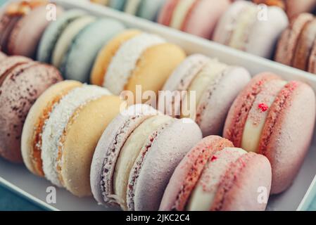 Colorful french macarons background, close up. Tasty sweet color macaroon. Bakery concept.Selective focus. Stock Photo