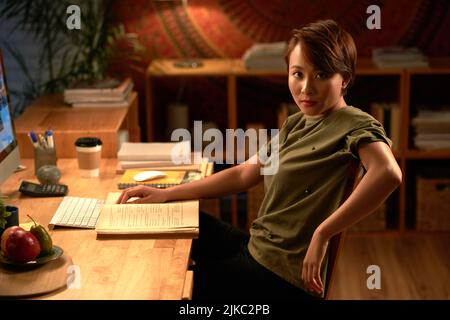Asian female student with short hair looking at camera while preparing for exam at night Stock Photo