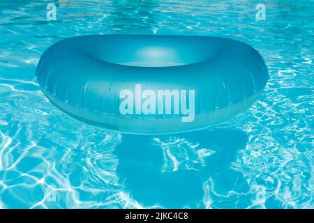 Blue summer pool rubber ring floating on a vacation swimming pool Stock Photo