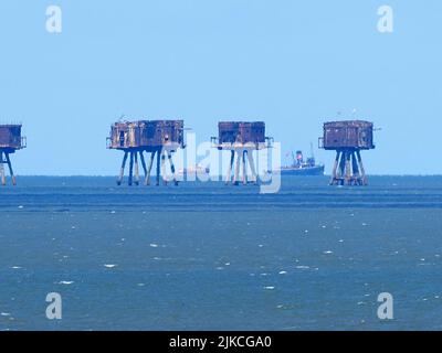 Sheerness, Kent, UK. 1st Aug, 2022. Knock John naval fort was sunk in the Thames Estuary several miles out to sea 80 years ago today. To celebrate Margaret McEwan (a Maunsell Forts enthusiast) arranged for historic tug steam tug Challenge to revisit the fort it helped to position 80 years ago. Ms McEwan was aboard X-Pilot vessel with members of the Sealand 'Royal Family' to mark the occasion. PIC: Challenge (large vessel) and X-Pilot pass the Red Sands Sea Forts (also designed by Guy Maunsell). Credit: James Bell/Alamy Live News Stock Photo