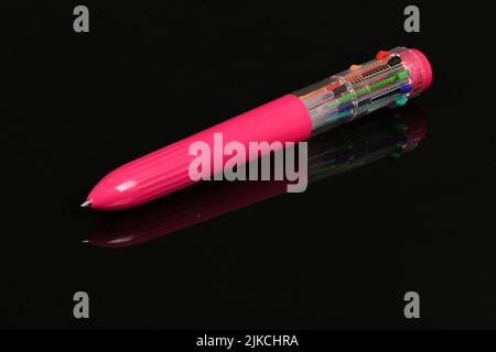 Pink multicolored pen isolated on black mirror background. High resolution photo. Full depth of field. Stock Photo