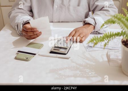 Top view of women's hands with a calculator and bills Stock Photo