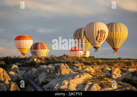 GOREME/TURKEY - June 27, 2022: hot air balloons flying over the hills of goreme. Stock Photo