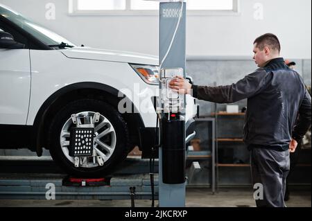 Auto mechanic sets american SUV car for diagnostics and configuration