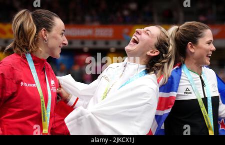 England's Laura Kenny (centre) laughs with her gold medal, alongside New Zealand's Michaela Drummond (right) with silver and Canada's Maggie Coles-Lyster with bronze after winning the Women's 10km Scratch Race Finals at Lee Valley VeloPark on day four of the 2022 Commonwealth Games in London. Picture date: Monday August 1, 2022. Stock Photo