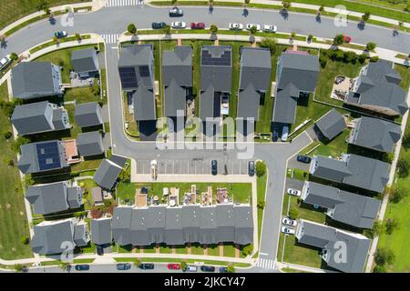 Aerial view of homes in the Greenway Village subdivision of Clarksburg, Montgomery County, Maryland. Several of the houses are outfitted with solar pa Stock Photo