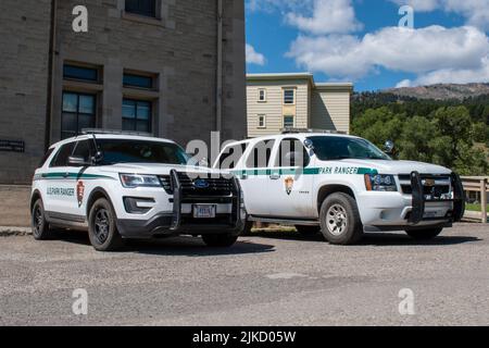 Two U.S. Park Ranger law enforcement vehicles parked in Mammoth Hot Springs in Yellowstone National Park. Stock Photo