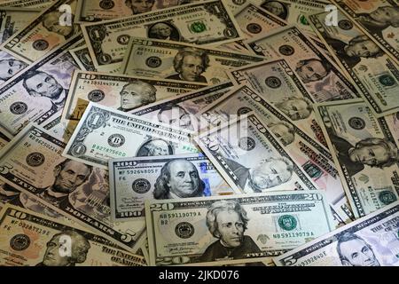 Banknotes of US dollars of different denominations arranged in random order Stock Photo