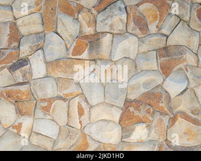 Wall cladding with coarse decorative spotted red stone. Not a seamless texture. Stock Photo