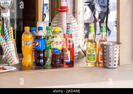 A set of various sugary drinks and beer, different cold beverage brands on an outdoors market stall, shop, group of objects closeup, nobody, no people Stock Photo