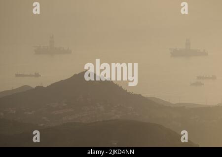 Oil rigs in the northeast coast of Gran Canaria under a dense haze formed by airborne dust. Las Palmas de Gran Canaria. Canary Islands. Spain. Stock Photo