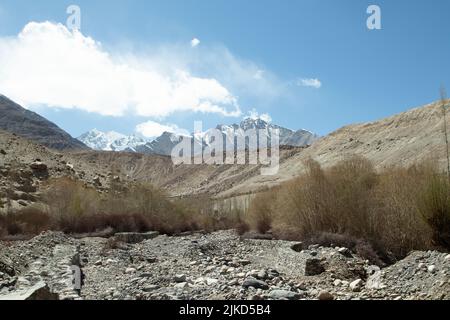 Beautiful Landscape Scenery Of The Great HImalayan Range Rocks And Glaciers With Dramatic Clouds In Blue Sky In Ladakh And Leh CIty Of India Stock Photo