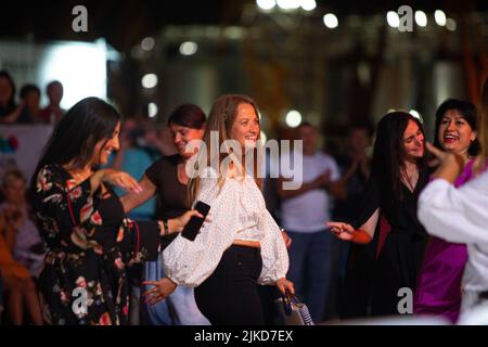 Odessa, Ukraine August 11, 2019: Many spectators at concert. crowd of visitors to concert has fun and shoots what is happening on smartphones. Fans at Stock Photo