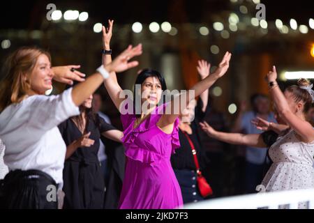 Odessa, Ukraine August 11, 2019: Many spectators at concert. crowd of visitors to concert has fun and shoots what is happening on smartphones. Fans at Stock Photo