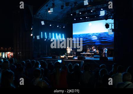 Odessa, Ukraine August 11, 2019: Many spectators at concert. crowd of visitors to concert has fun and shoots what is happening on smartphones. Fans at Stock Photo