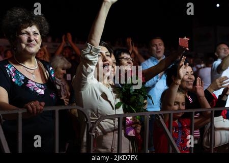 Odessa, Ukraine August 11, 2019: Many spectators at concert. crowd of visitors to concert has fun and shoots what is happening on smartphones. Fans at Stock Photo