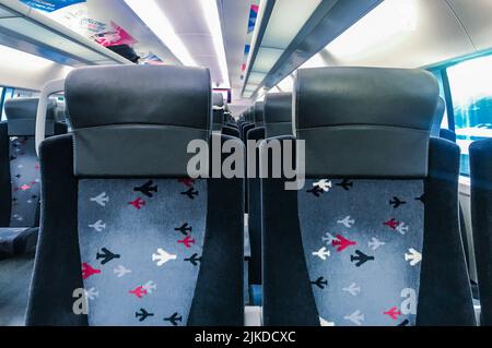 Moscow, Russia, March 2019: Seats in an empty carriage of an Aeroexpress high-speed train. Airport railway line. On the soft upholstered chairs - mult Stock Photo