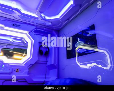 Moscow, Russia, March 2019: Interior of futuristic Capsule hotel. Inside the capsule: sleeping place mirror, control panel and headphones on the wall. Stock Photo