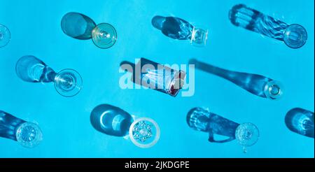 shadows of multiple glasses on bright blue background, abstract repetitive pattern Stock Photo