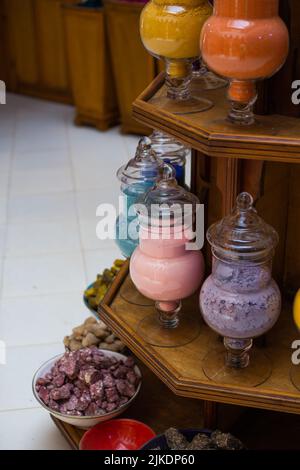 Arabian style glass pots with colourful mineral and tasty ingredient spices in a spices market in Marrakesh Stock Photo