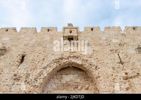 The upper part of Zion Gate, one of the seven gates of the old city of Jerusalem. There are many bullet holes that are clearly seen on the stone. Stock Photo