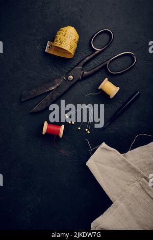 Old vintage sewing accessories. Needle with threads. Scissors. Centimeter.  Thimble Stock Photo - Alamy