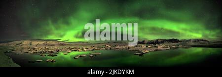 Iceland's largest and most famous glacial lake, Jökulsárlón, captured at night with a display of Aurora Borealis overhead. Stock Photo