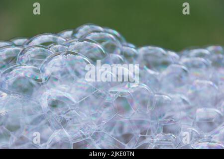 Huge pile of soap bubbles with green background Stock Photo