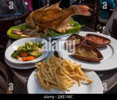 Fish meal with vegetables and sauces in Mexican fish restaurant Mexico City, Mexico Stock Photo