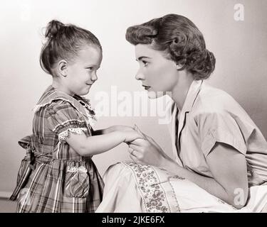 1940s 1950s WOMAN MOTHER HAVING A SERIOUS FACE-TO-FACE TALK WITH HER LITTLE GIRL DAUGHTER  - j1050 HAR001 HARS OLD FASHION 1 JUVENILE STYLE FEAR COMMUNICATION SECURITY YOUNG ADULT SAFETY TEAMWORK STRONG LIFESTYLE PARENTING FEMALES HEALTHINESS HOME LIFE HALF-LENGTH LADIES DAUGHTERS PERSONS THOUGHTFUL DISCIPLINE INSPIRATION CARING RISK CONFIDENCE B&W KNEELING HAPPINESS WELLNESS PROTECTION STRENGTH CONFRONTATION POWERFUL WARNING HOLDING HANDS AUTHORITY FACE TO FACE CONCEPTUAL SUPPORT SINCERE PERSONAL ATTACHMENT SOLEMN AFFECTION EMOTION FOCUSED GROWTH INTENSE JUVENILES MOMS TOGETHERNESS Stock Photo