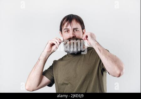 Portrait of a bearded mustachioed shaggy man. Stock Photo