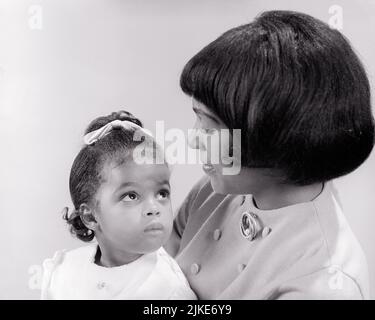 1960s PORTRAIT OF AFRICAN-AMERICAN TODDLER GIRL LOOKING UP AT HER MOTHER WITH A TRUSTING LOVING GLANCE - j12539 HAR001 HARS FACIAL YOUNG ADULT STRONG FAMILIES LIFESTYLE FEMALES STUDIO SHOT HOME LIFE COPY SPACE LADIES DAUGHTERS PERSONS CARING EXPRESSIONS B&W HEAD AND SHOULDERS AFRICAN-AMERICANS AFRICAN-AMERICAN BLACK ETHNICITY GLANCE UP LOVING MOTHER AND CHILD TRUSTING RELATED PERSONAL ATTACHMENT AFFECTION EMOTION GROWTH JUVENILES MID-ADULT MID-ADULT WOMAN MOMS QUESTIONING TOGETHERNESS WORRYING YOUNG ADULT WOMAN BABY GIRL BLACK AND WHITE HAR001 OLD FASHIONED AFRICAN AMERICANS Stock Photo
