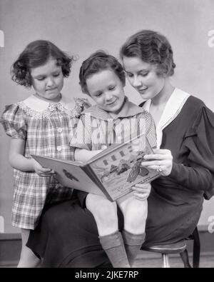 1930s WOMAN MOTHER READING TO GIRL DAUGHTER AND BOY SON FROM A STORYBOOK ABOUT A DUTCH BOY NAMED KEES AND HIS PET DUCK   - j264 HAR001 HARS SUBURBAN URBAN MOTHERS PET OLD TIME BUSY NOSTALGIA BROTHER READ OLD FASHION SISTER 1 DUCK JUVENILE STYLE COMMUNICATION YOUNG ADULT TEAMWORK STRONG SONS PLEASED FAMILIES JOY LIFESTYLE PARENTING FEMALES BROTHERS HOME LIFE COPY SPACE HALF-LENGTH LADIES DAUGHTERS PERSONS CARING MALES SIBLINGS DUTCH SISTERS B&W HAPPINESS CHEERFUL HIS AND RECREATION PRIDE STORYBOOK SIBLING SMILES CONNECTION CONCEPTUAL JOYFUL STYLISH PERSONAL ATTACHMENT AFFECTION EMOTION GROWTH Stock Photo