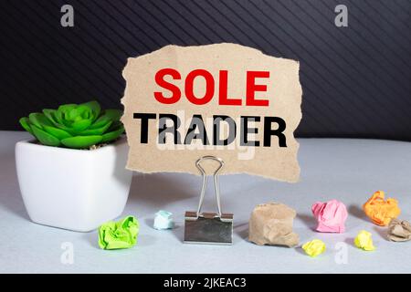 text sole trader on stickers on the diary with office tools. Stock Photo