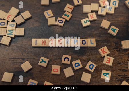 Top view of colorful square wooden letters creating the word INTERPOL. The International Criminal Police Organization concept. High quality photo Stock Photo