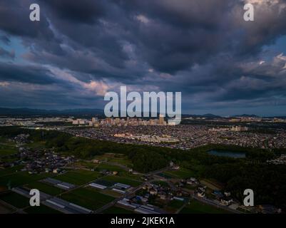 Dramatic clouds over small suburban development at dusk Stock Photo