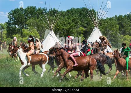 American Indian braves race to war on horseback during the annual reenactment of the Little Bighorn Battle, Montana Stock Photo