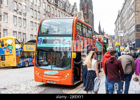 The Royal Mile Edinburgh, double decker red city explorer tour bus passengers getting on board for city tour of Edinburgh,Scotland,UK summer 2022 Stock Photo