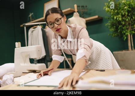 Sketch of new fashion dress, female hand drawing on paper, holding pencil. Clothes  Design concept Stock Photo - Alamy