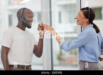 Plotting for our success. two business colleagues planning their work. Stock Photo