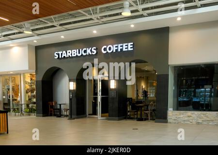 An open door leading to inside a local Starbucks Coffee shop located inside a mall, Maple Ridge, B. C., Canada. Stock Photo