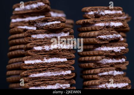 puff pastry chocolate chip sandwiches with creamy filling, crispy fresh cookies with cocoa and buttercream Stock Photo