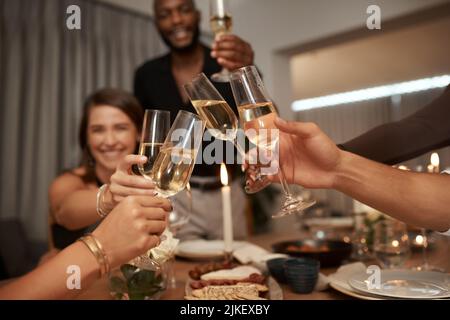 To the best group of friends. a diverse group of friends celebrating New Years together and toasting with glasses of champagne. Stock Photo